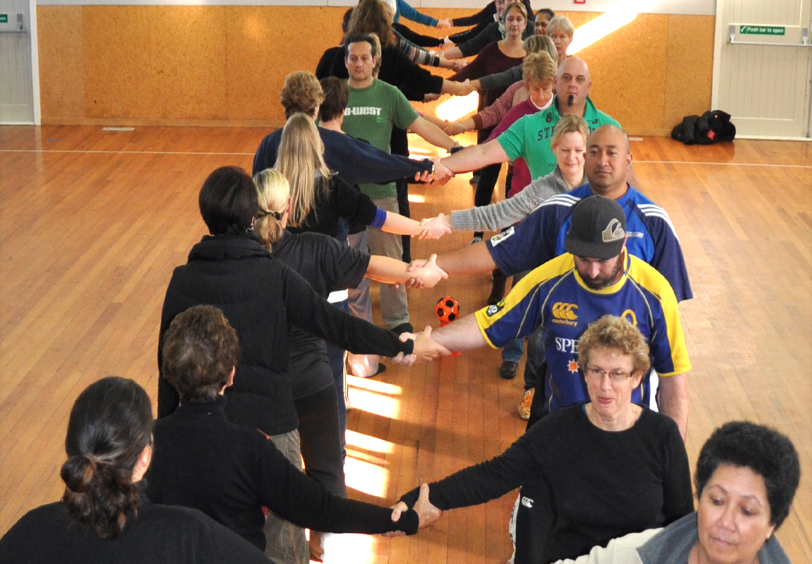 Staff from a school lined up ready to do a Rock and Water exercise together